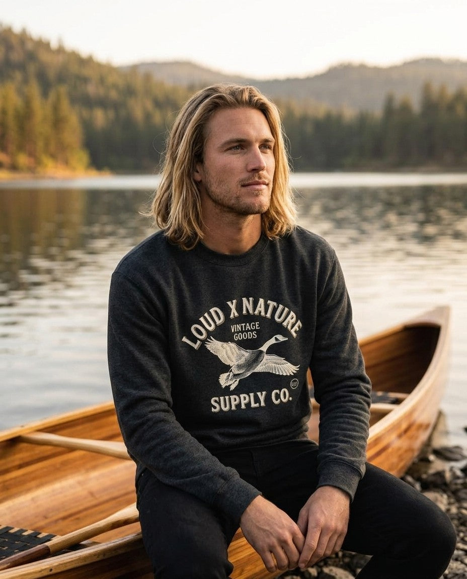 Northern Goose crewneck by a cedar canoe